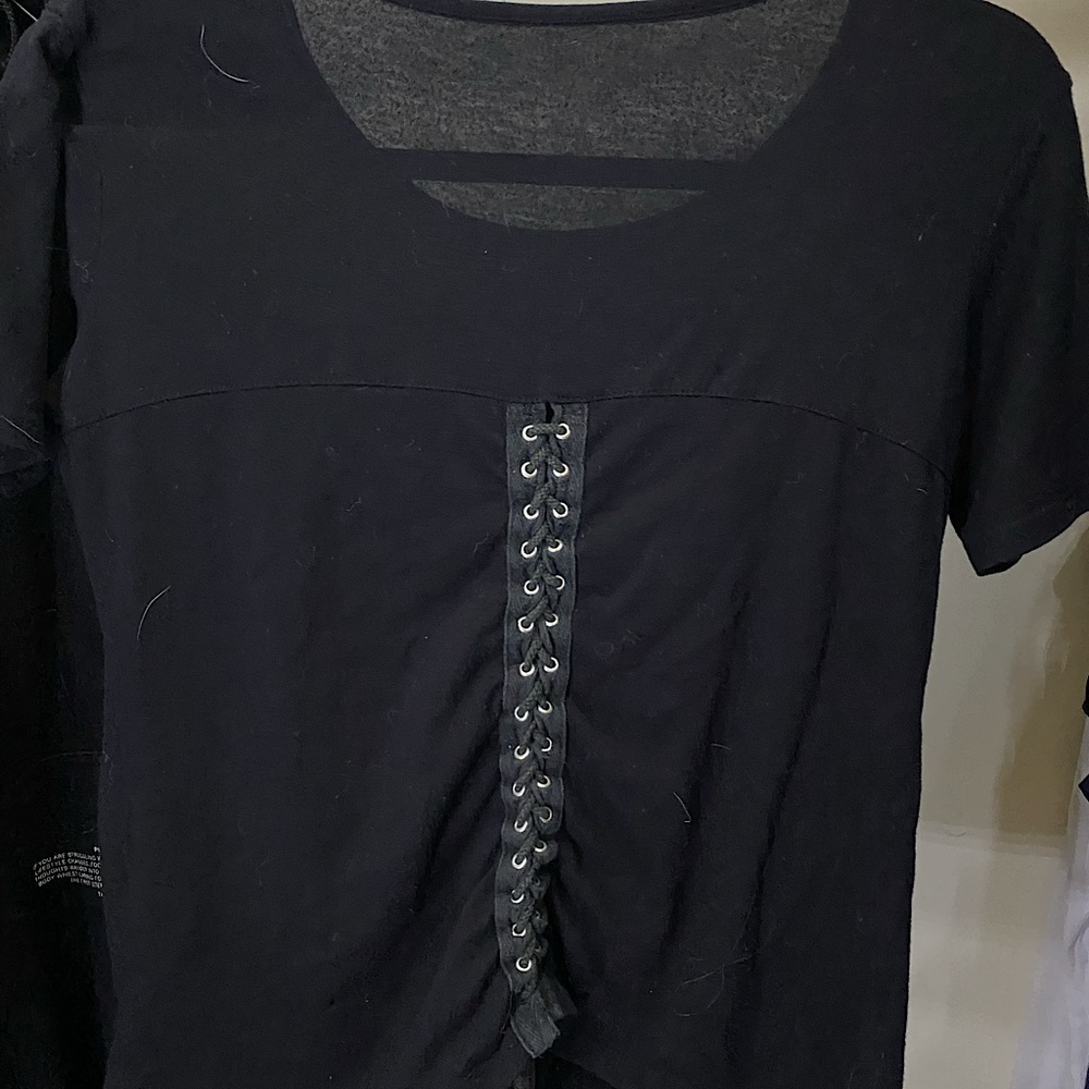 Black shirt with a custom be nice patch